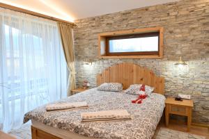 Postel nebo postele na pokoji v ubytování Villa Letizia near the Pirin Golf Resort