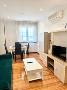 a living room with a couch and a table at La Perla del Castro in Vilagarcia de Arousa