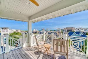a porch with chairs and a view of the ocean at Beach Bear Cottage in Watersound Beach