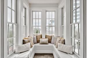 a white room with windows with pillows on a bench at Savannah 1E in Rosemary Beach +29 photos