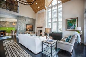 a living room with a white couch and a fireplace at Benoit Cottage in Rosemary Beach