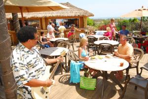 a group of people sitting at tables at a restaurant at Sea Crest Oceanfront Resort in Myrtle Beach