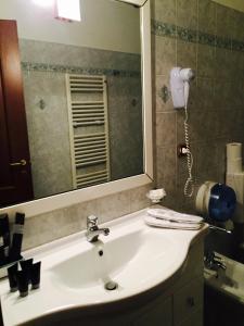 a bathroom with a white sink and a mirror at Hotel Martin in Volpiano