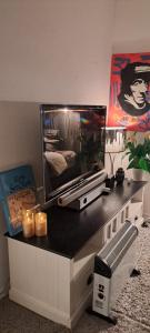 a tv sitting on top of a table with candles at Kule gule huset in Svolvær