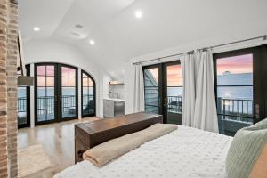 a bedroom with a bed and views of the ocean at Oasis Cottage & Carriage House in Rosemary Beach