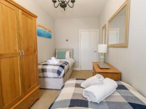 Un pequeño dormitorio con dos camas y una mesa. en Two No36, en Weymouth