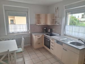 a kitchen with a sink and a stove top oven at Ferienwohnung in der Korbstadt Lichtenfels in Lichtenfels