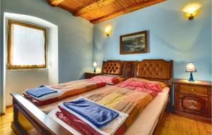 a bedroom with two beds and a dresser and a window at Cozy Home In Kastel With Wifi in Kaštel