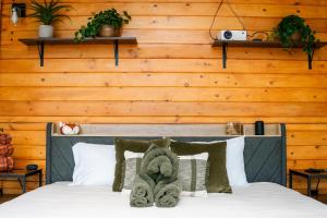 a bedroom with a bed with a wooden wall at Romantic Dome Retreat for Couples in Ellijay