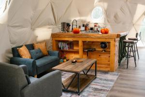 a room with a table and chairs in a tent at Romantic Dome Retreat for Couples in Ellijay +19 photos