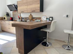 a kitchen with a wooden counter top in a room at La soie in Allevard