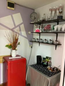 a room with a red refrigerator and a table at Apartment boulevard Cetate in Alba Iulia +24 photos
