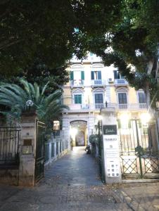a large white building with a gate in front of it at Amedeo Square in Naples +107 photos