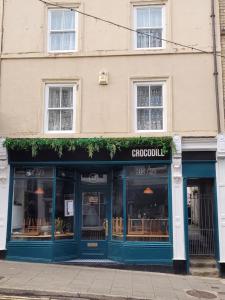a store front of a building with blue doors at Lupine Cottage in Whitby