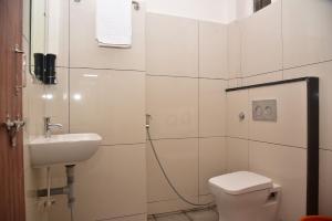 a bathroom with a toilet and a sink at NV Comforts in Rānībennur