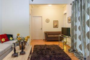 a living room with a couch and a table at Joanna's city centre apartment in Tripoli