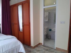 a bedroom with a red door and a bathroom at VvEK B&B APARTMENT in Arusha +123 photos