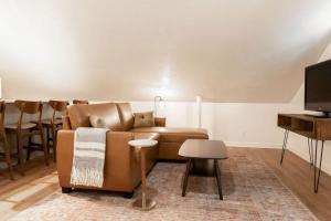 a living room with a couch and a table at The Loft at Park Place Cozy Studio on the Park in Columbus