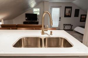 a kitchen sink with a white counter top at The Loft at Park Place Cozy Studio on the Park in Columbus +12 photos