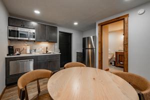 a kitchen with a wooden table and chairs at Cove Creek Lodge 101 Poolside Executive King Suite in Oakland