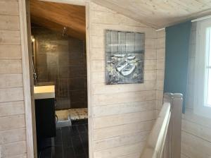 a bathroom with a shower and a bath tub at Petite maison de village Eloise proche de la plage in Sainte-Marie-de-Ré +3 photos