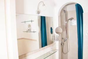 a bathroom with a shower with a blue shower curtain at Shangrila in Rome +47 photos