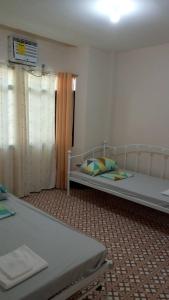 a bedroom with two beds in a room at JMC1 Room1 Tagbilaran City Bohol in Tagbilaran City