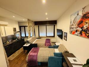 a bedroom with two beds and a couch at Grande Bellezza Luxury Suite in Mestre