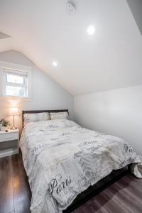 a white bedroom with a bed and a window at Cozy and Modern 2br guesthouse in Vancouver