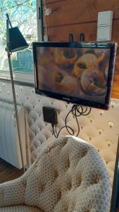 a television with a picture of donuts on it at Le Petit Cavron in Cavron-Saint-Martin
