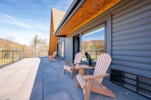 a patio with two chairs and a table on a house at Cove Creek Lodge 202 Poolside Double Queen Room in Oakland +4 photos