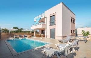 a villa with a swimming pool and a house at Villa Karizma - sea view, swimming pool, hot tub, Brijuni, Fazana, Peroj in Peroj