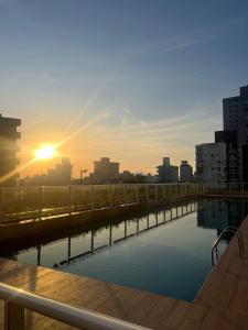 a view of a city skyline with the sun setting at Summer Holiday com Piscina Climatizada - Piçarras in Piçarras +41 photos