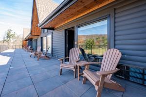 a patio with chairs and a table on a house at Cove Creek Lodge 205 Poolside Double Queen Room in Oakland