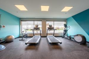 a gym with treadmills and exercise bikes in a room at avid hotels - Kalamazoo East by IHG in Kalamazoo
