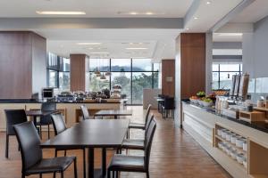 a restaurant with tables and chairs and a counter at Fairfield by Marriott Bogota Embajada in Bogotá