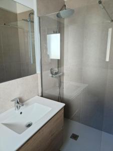 a bathroom with a sink and a glass shower at Quirós Villa Tranquila de Salcedo 1 in La Villa +9 photos