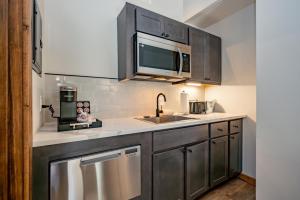 a kitchen with a sink and a microwave at Cove Creek Lodge 213 Dog Friendly Standard Double Queen Room in Oakland
