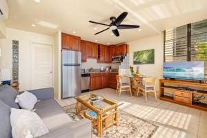 a living room with a couch and a table at Poipu Shores 101B in Koloa