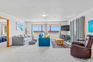 a living room with a couch and chairs and a tv at On-Site Kenai River Fishing Soldotna Apartment! in Soldotna