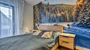a bedroom with a bed with a mountain mural on the wall at Belle View Szklarska Poręba Strefa SPA - Jacuzzi & Sauna in Szklarska Poręba