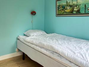 a bed in a room with a painting on the wall at 6 person holiday home in SÖLVESBORG-By Traum in Sölvesborg