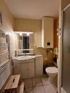 a bathroom with a toilet and a sink and a mirror at Résidence Roches Rousses B - studio box 5/6 personnes MAE-2776 in Orcières
