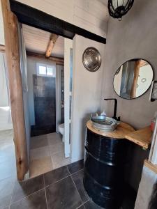 a bathroom with a barrel sink and a mirror at Posada Malbec in Uspallata