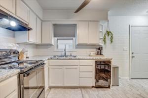 a kitchen with white cabinets and a sink at Andover Bungalow - Sleeps 6 in Andover