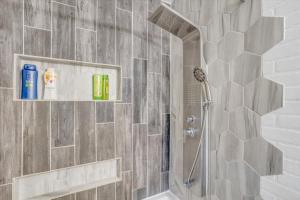a bathroom with a shower with a glass door at Andover Bungalow - Sleeps 6 in Andover +17 photos