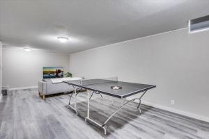 a ping pong table in a living room with a couch at Andover Bungalow - Sleeps 6 in Andover
