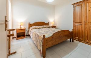a bedroom with a wooden bed and two night stands at Poiana in Orbetello +12 photos