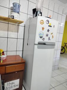 a refrigerator in a kitchen with stickers on it at Hostel e Camping da Cris in Carolina +23 photos
