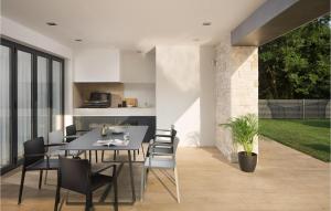 a kitchen and dining room with a table and chairs at Villa Eden in Ližnjan